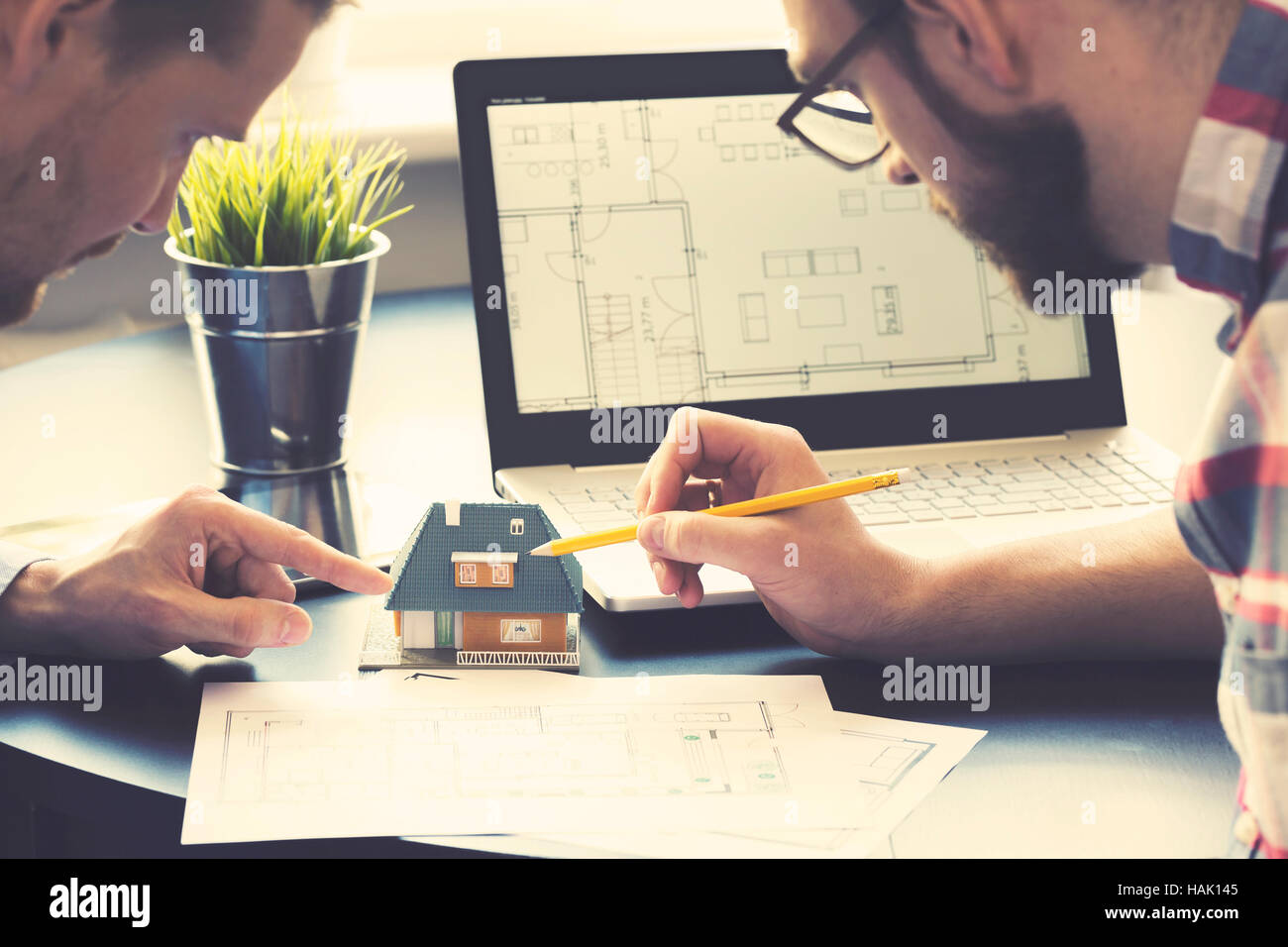architect showing new family house model to customer at office Stock Photo
