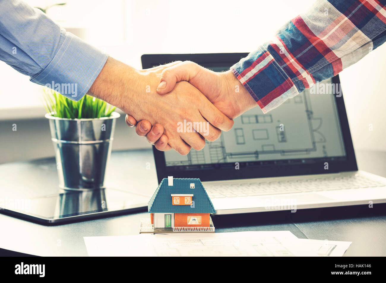 real estate agent shaking hands with customer after deal at office Stock Photo