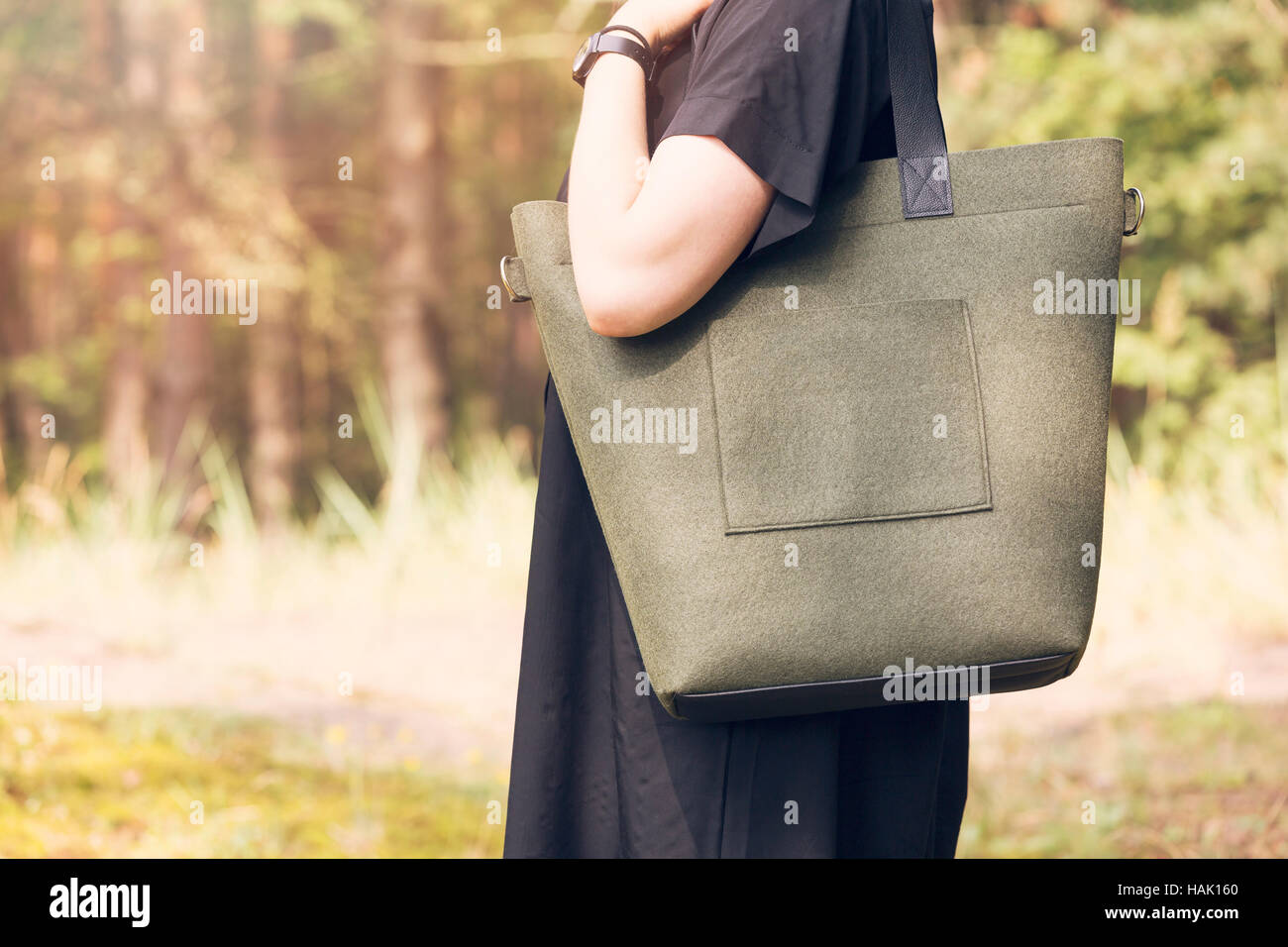 khaki color felt bag on woman's shoulder Stock Photo