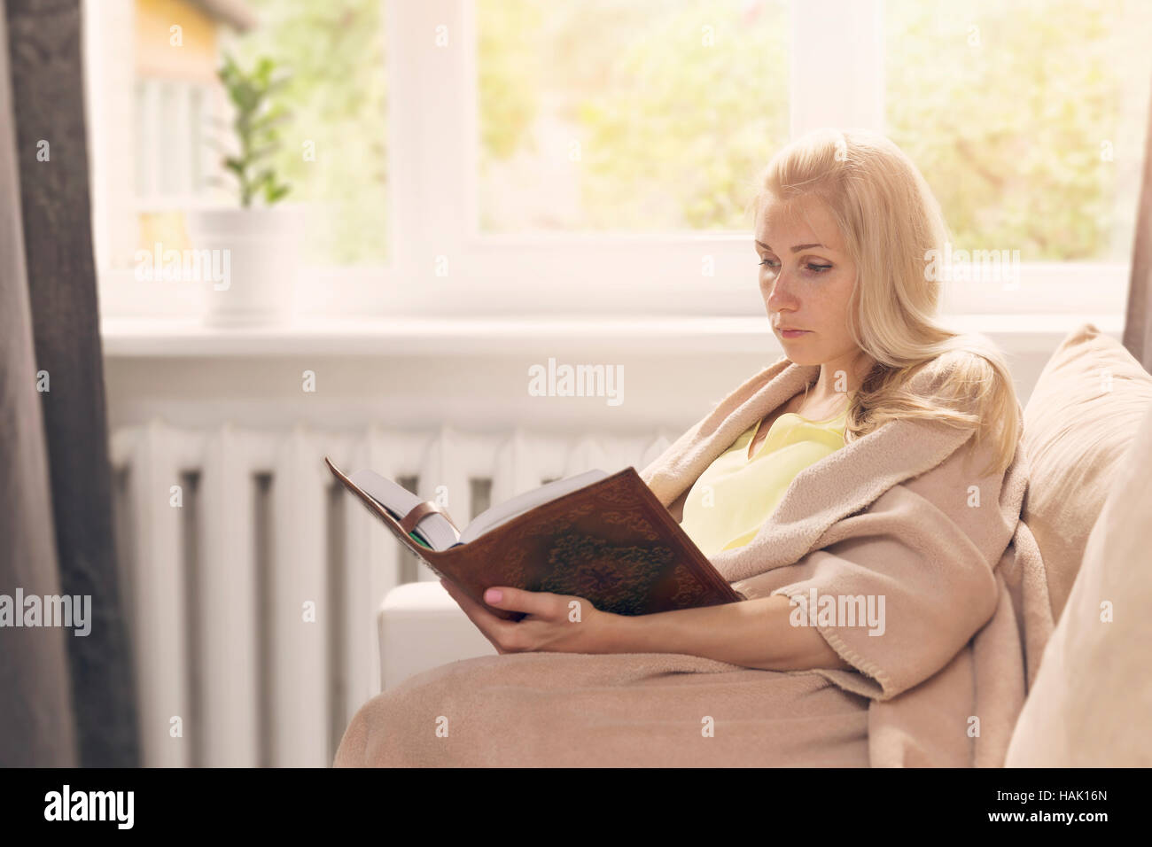 woman resting on the couch and read a book Stock Photo