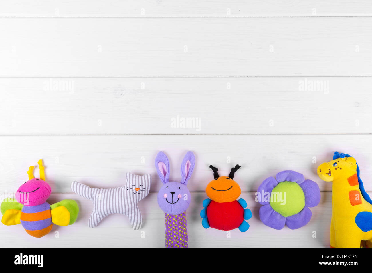stuffed baby toys on wooden background with copy space Stock Photo