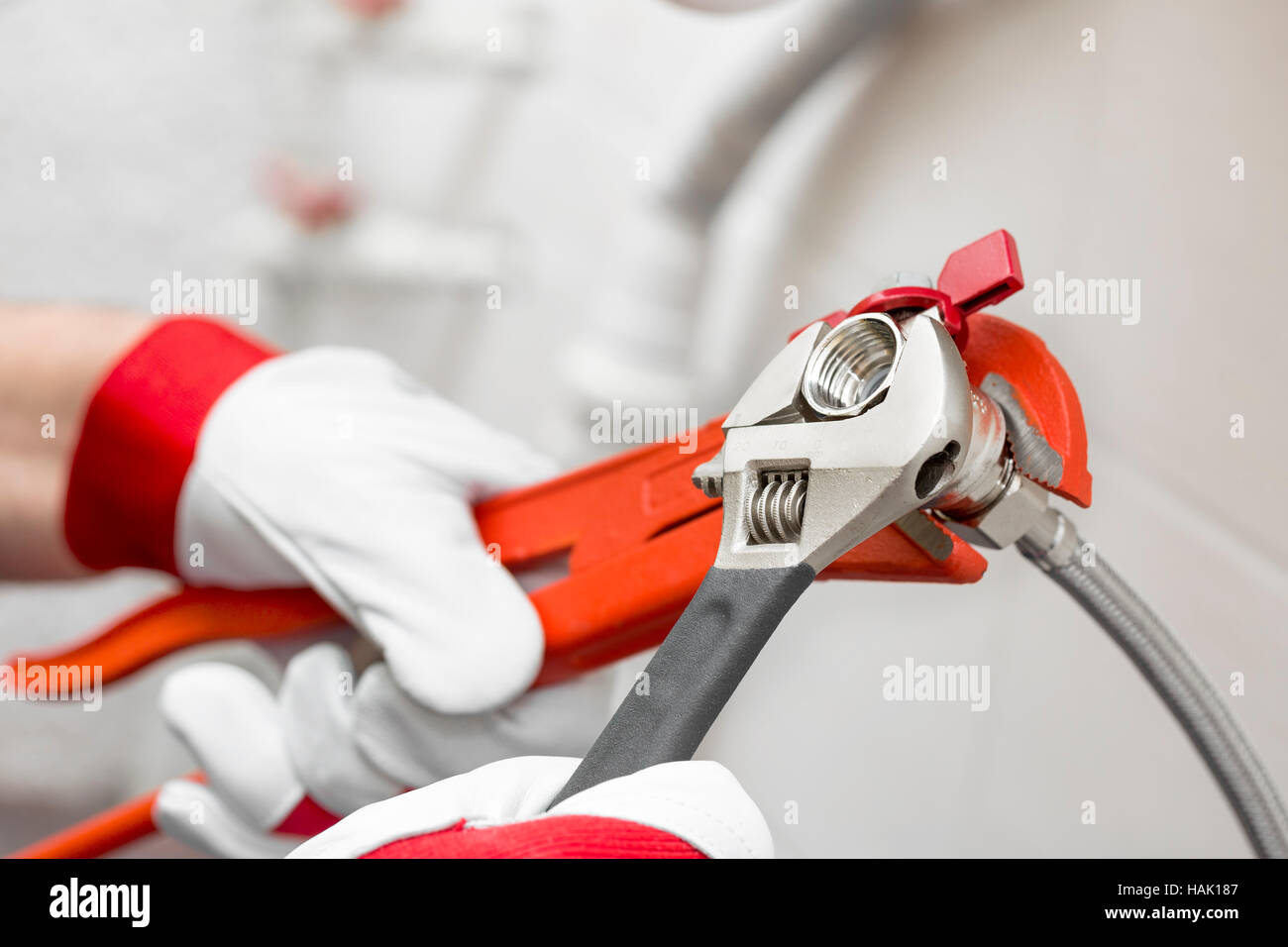 plumber screwing plumbing fittings in bathroom Stock Photo Alamy