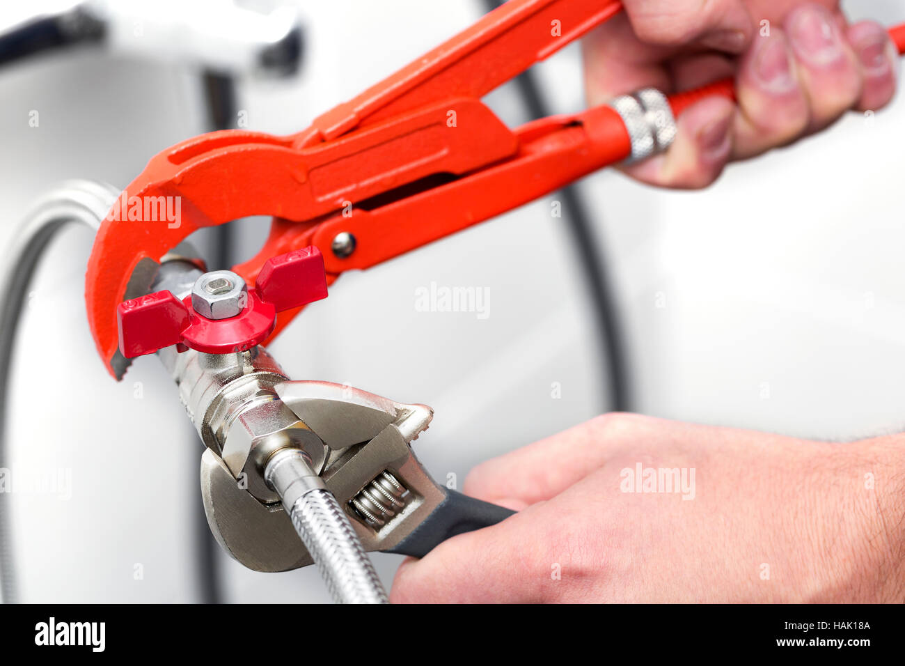 plumber screwing plumbing fittings in bathroom Stock Photo Alamy