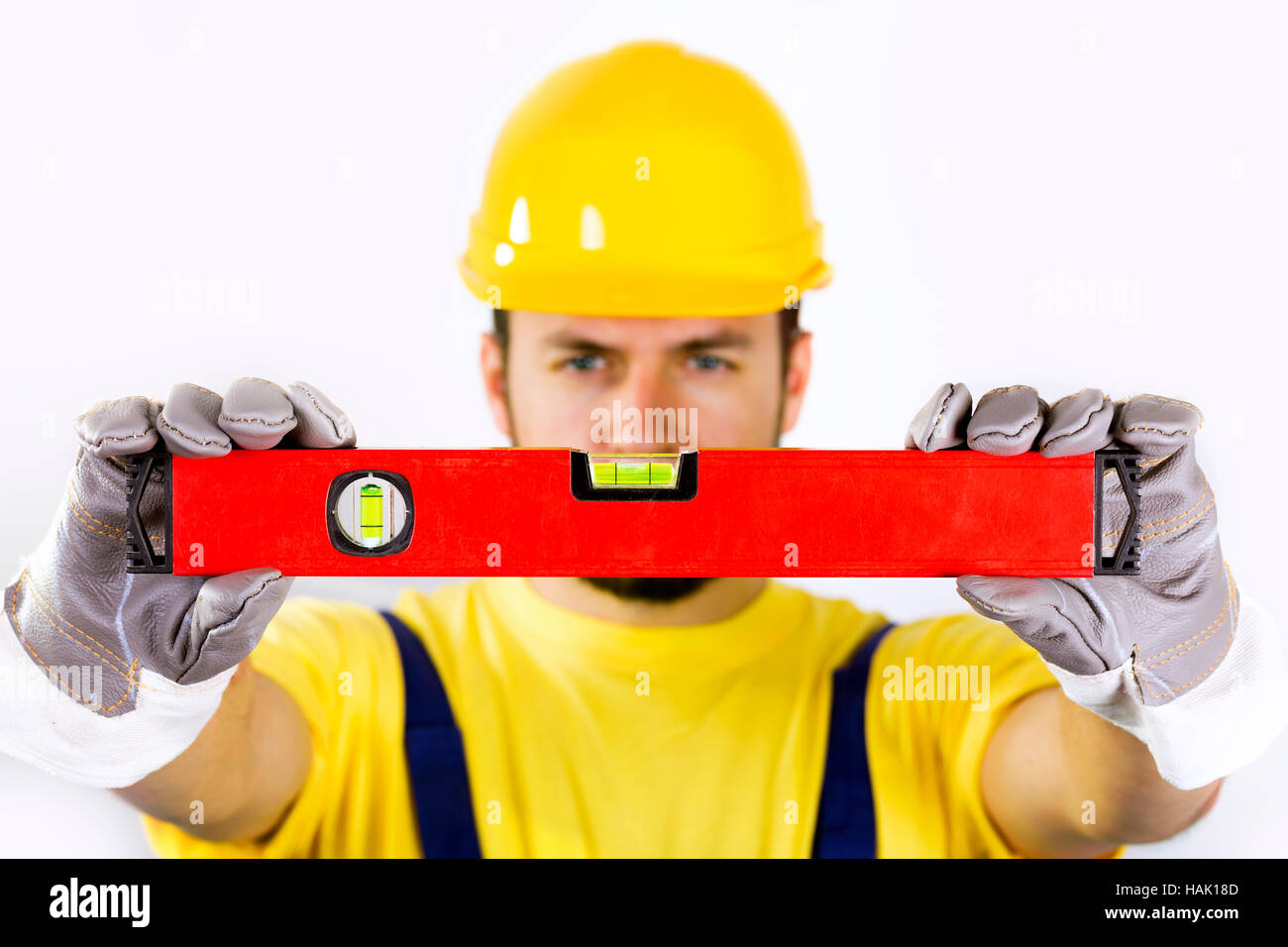 quality control - construction worker with spirit level Stock Photo