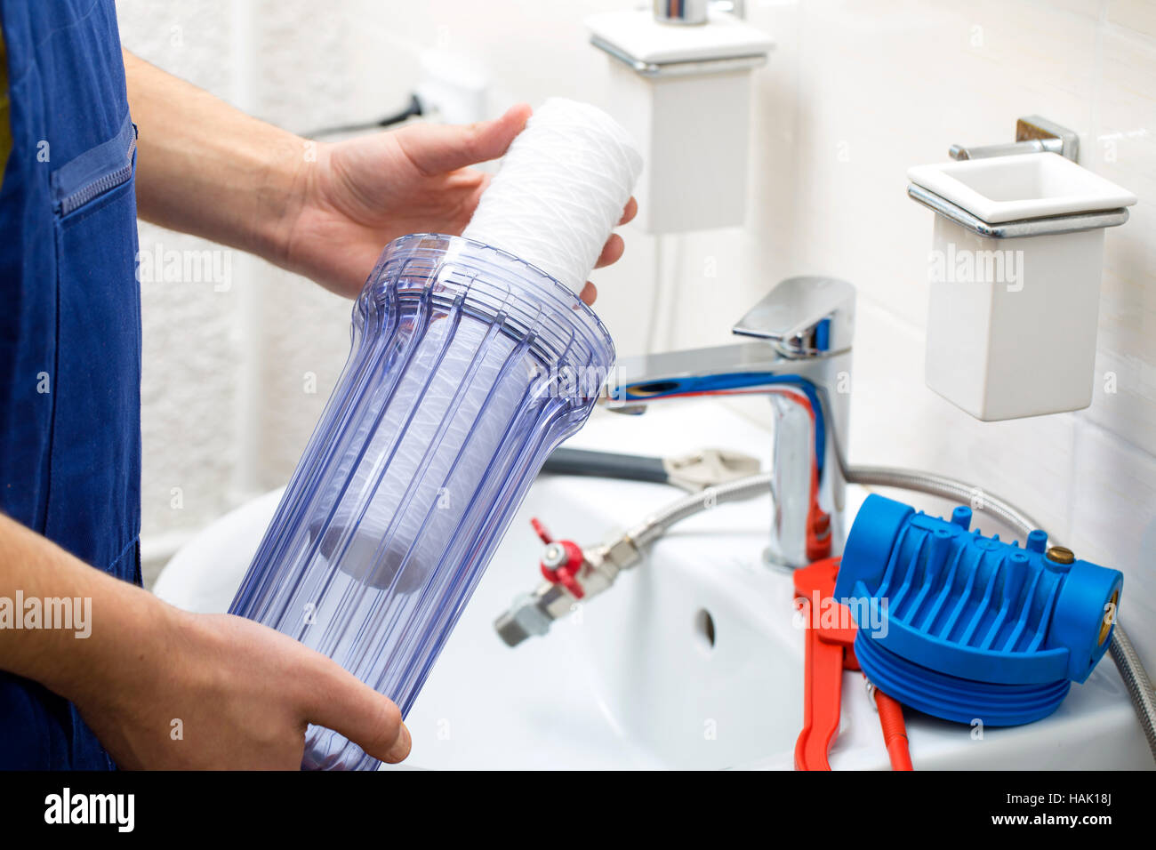 plumber installing new water filtration system Stock Photo