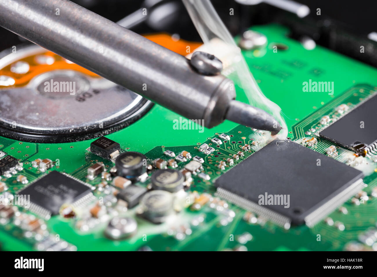 macro shot of soldering iron and circuit board Stock Photo