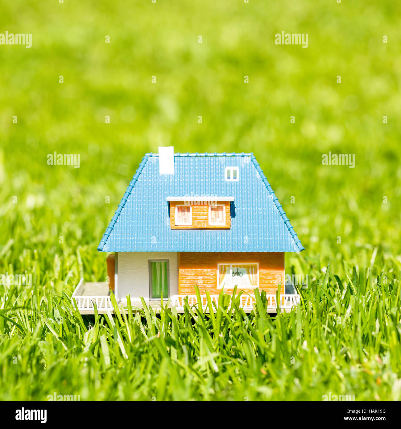 small plastic house on green grass Stock Photo