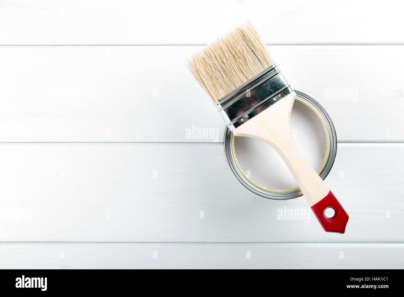 paint can with paintbrush on white wooden background with copyspace Stock Photo
