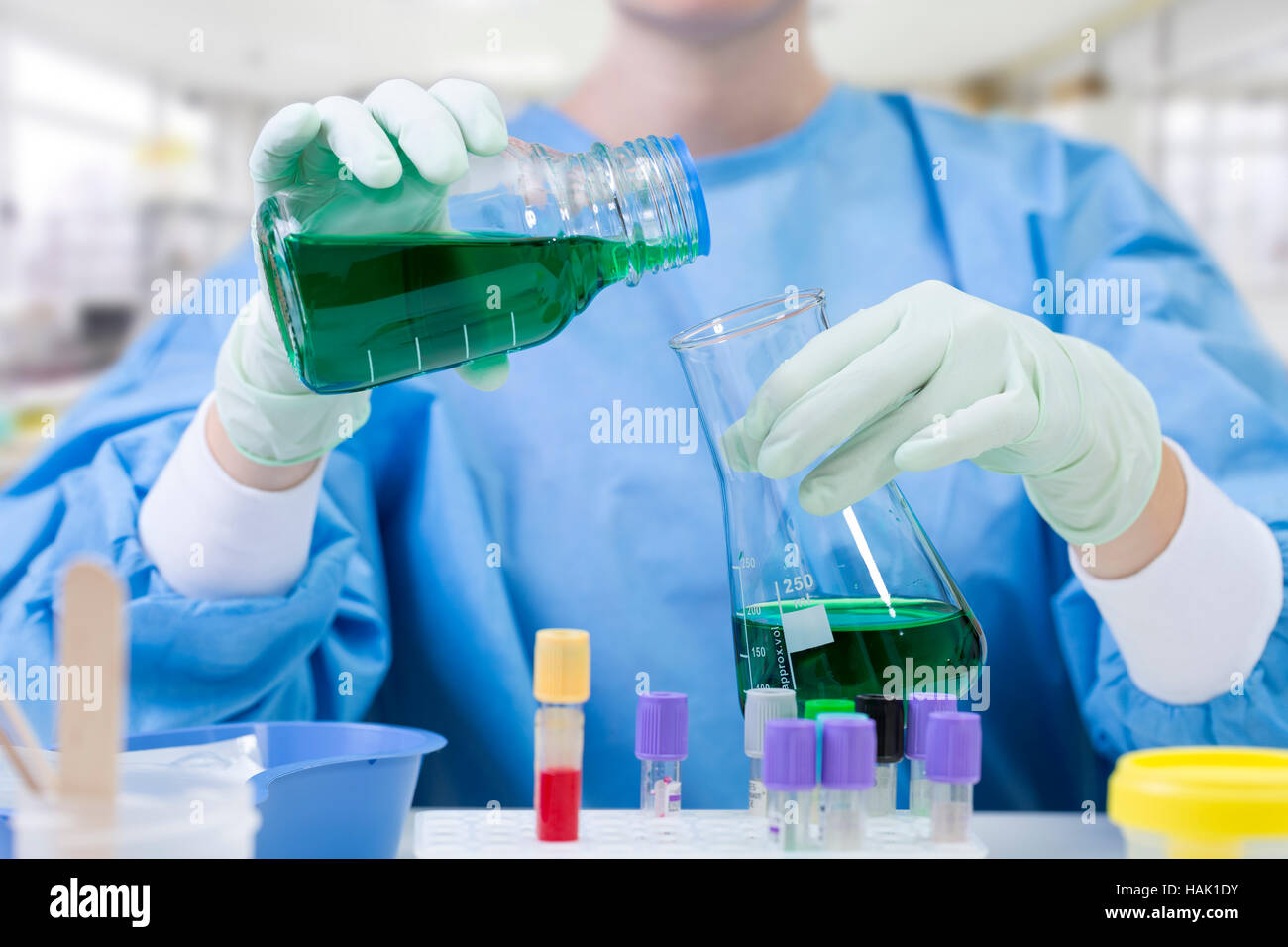 scientist filling a flask in a chemical laboratory Stock Photo