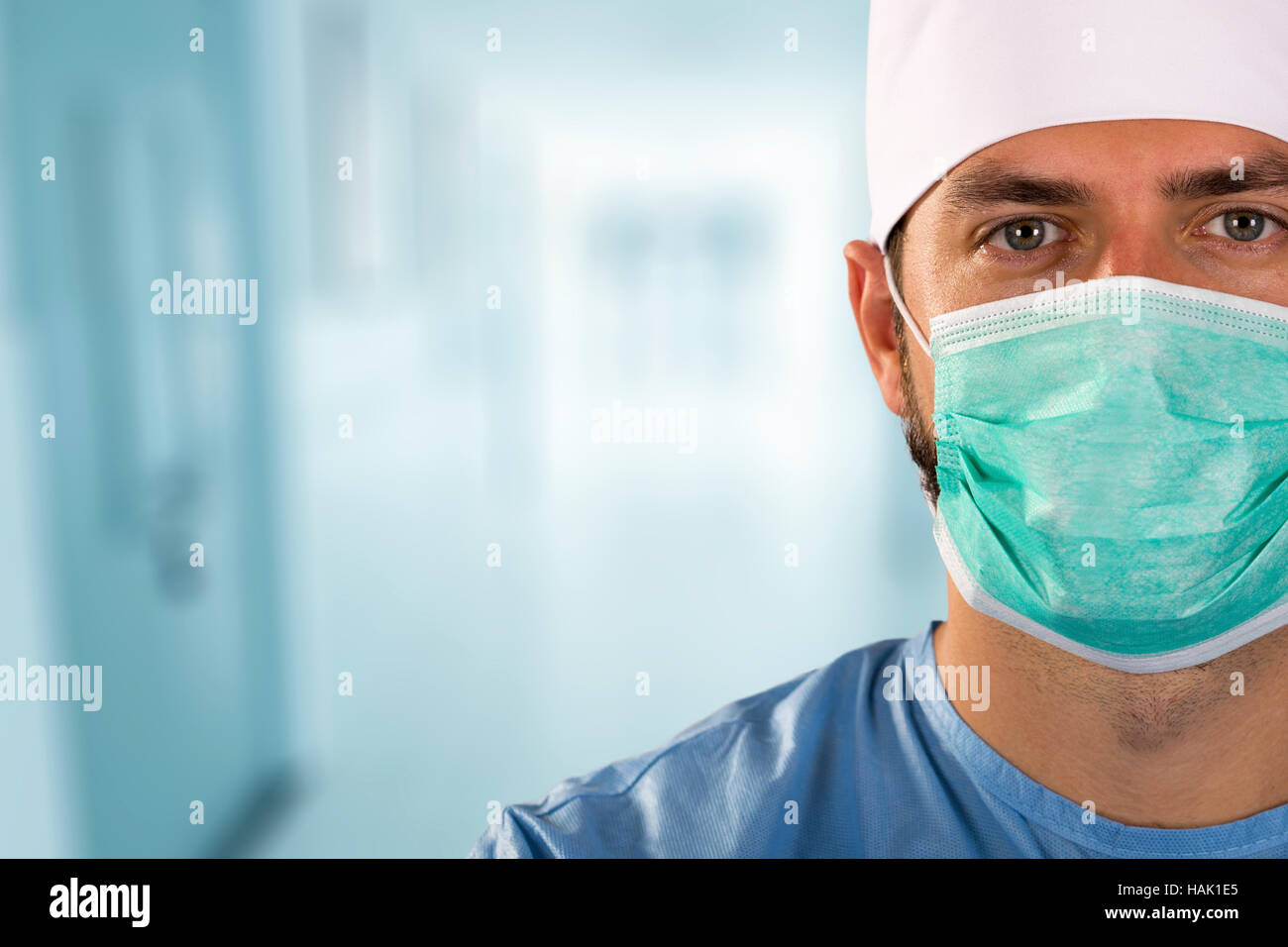 doctor surgeon with face mask standing in the hospital hallway Stock Photo