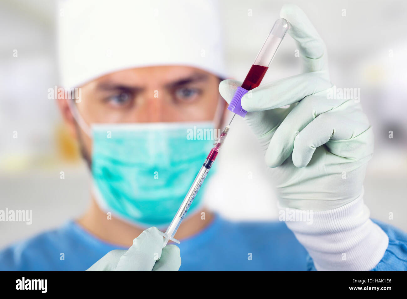 blood analysis - doctor with syringe in front of face Stock Photo