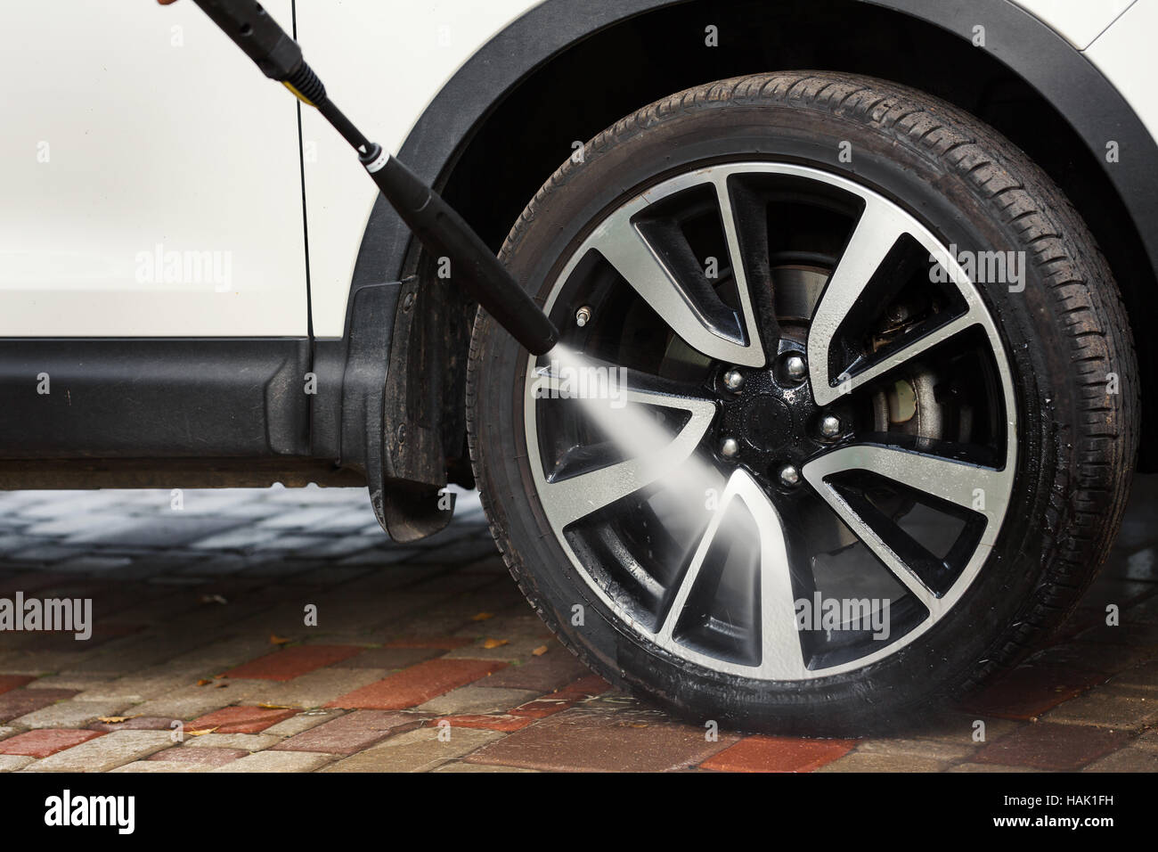 car wheel washing with high pressure washer Stock Photo