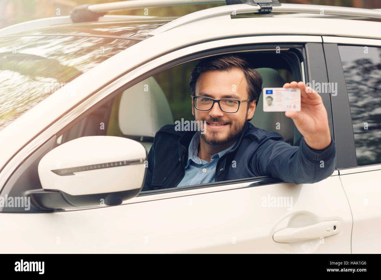 young happy man showing his new driver license Stock Photo