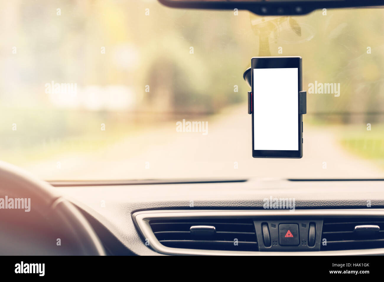 mobile phone with blank screen in car windshield holder Stock Photo
