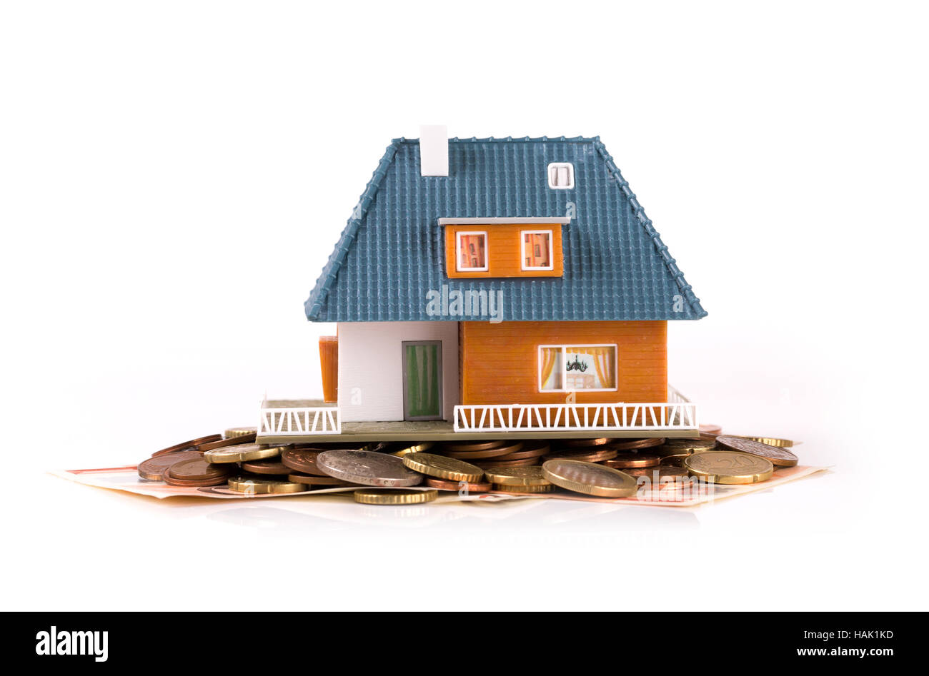 mortgage concept - house on heap of money Stock Photo