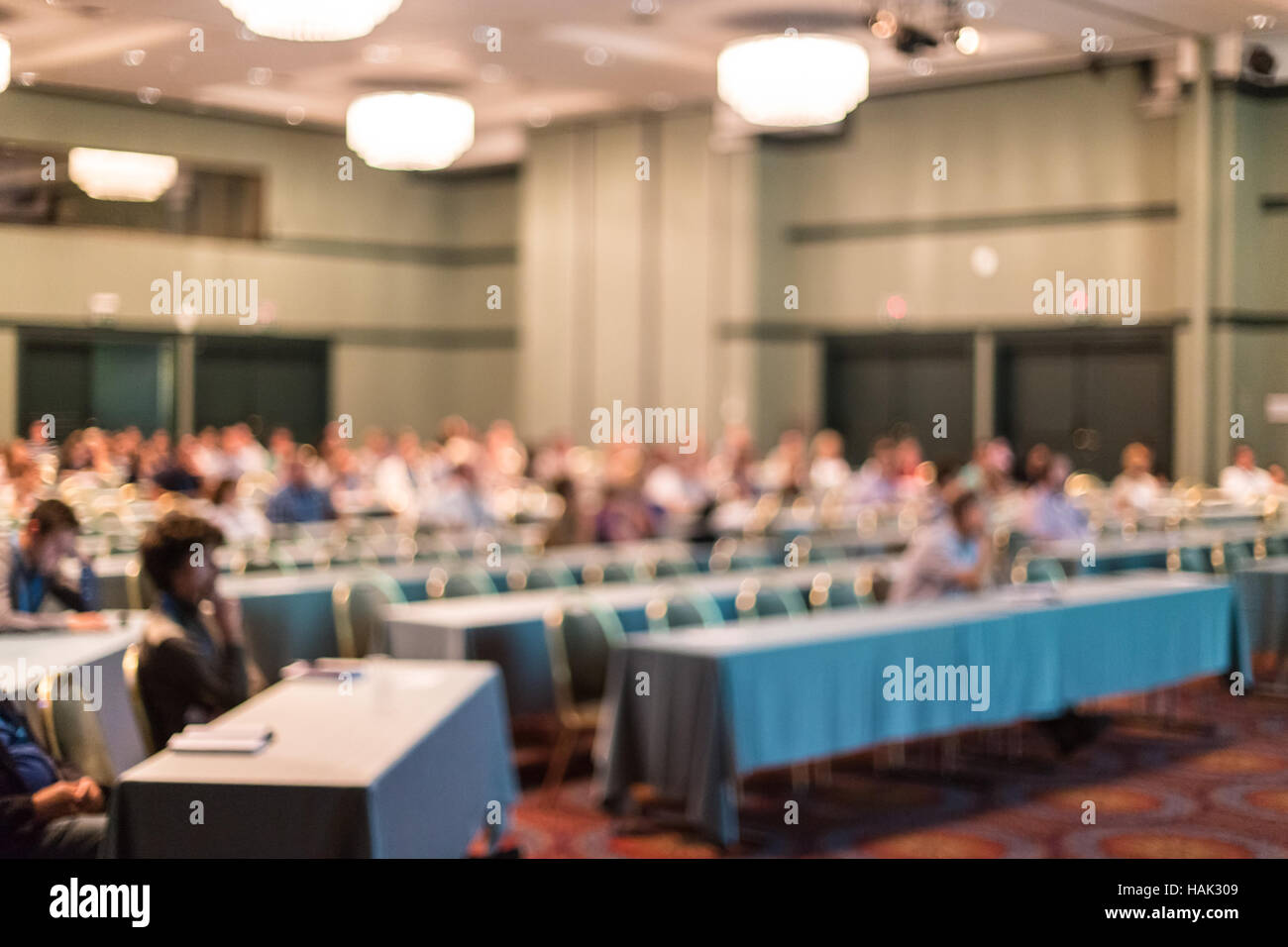 Blured image of audience in conference hall attending business