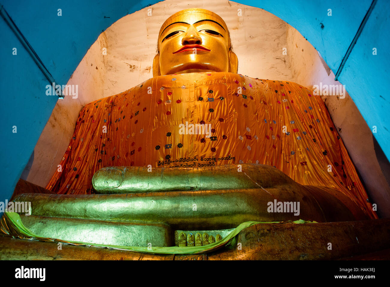 BAGAN, Myanmar - Built in 1067, Manuha Temple features massive statues of The Buddha crammed within spaces barely large enough to hold them. An especially large reclining Buddha is a particular highlight. The temple is located in Myinkaba Village inside the Bagan Archaeological Zone. Stock Photo