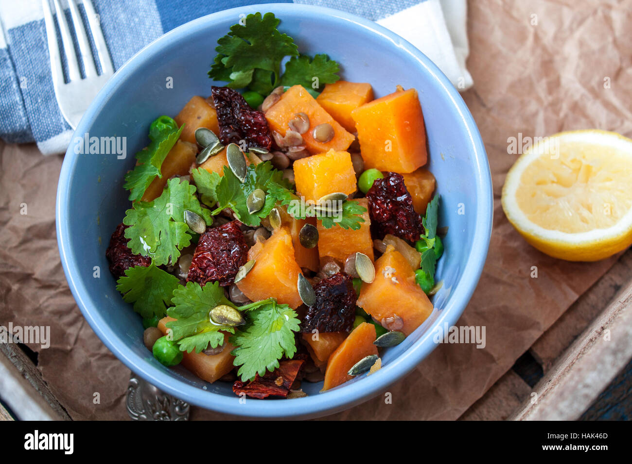 Vegan garnish. Boiled sweet potatoes with green peas, cilantro and linseed oil. Perfect for the detox diet or just a healthy meal.  Love for a healthy Stock Photo