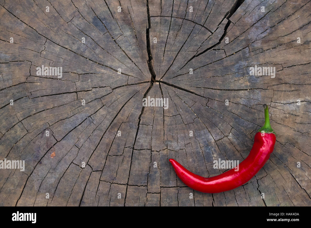 A pod of red hot chili peppers on the old worn wooden background Stock ...