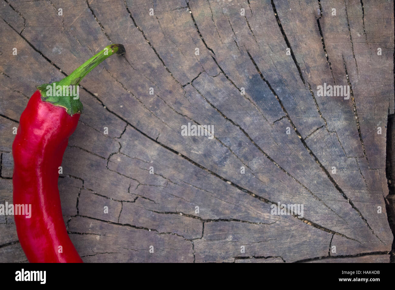 A pod of red hot chili peppers on the old worn wooden background Stock ...
