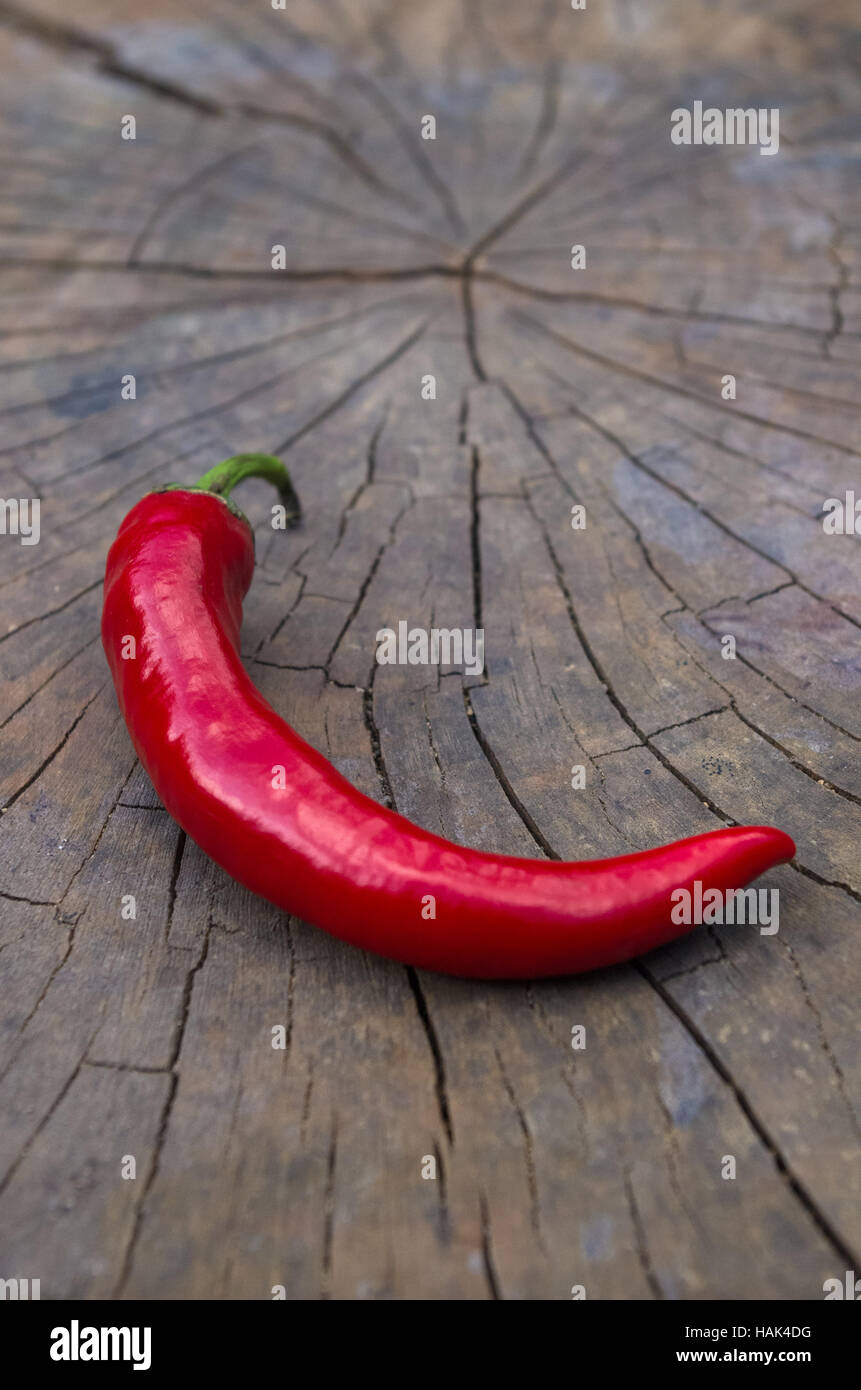 A pod of red hot chili peppers on the old worn wooden background Stock ...