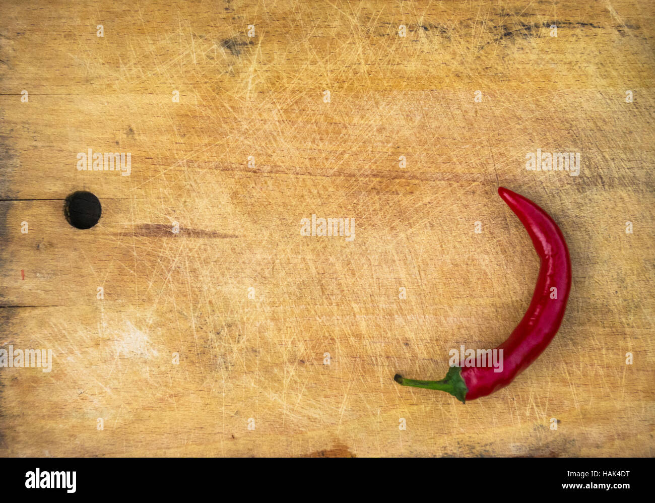A pod of red hot chili peppers on the old worn wooden background Stock ...