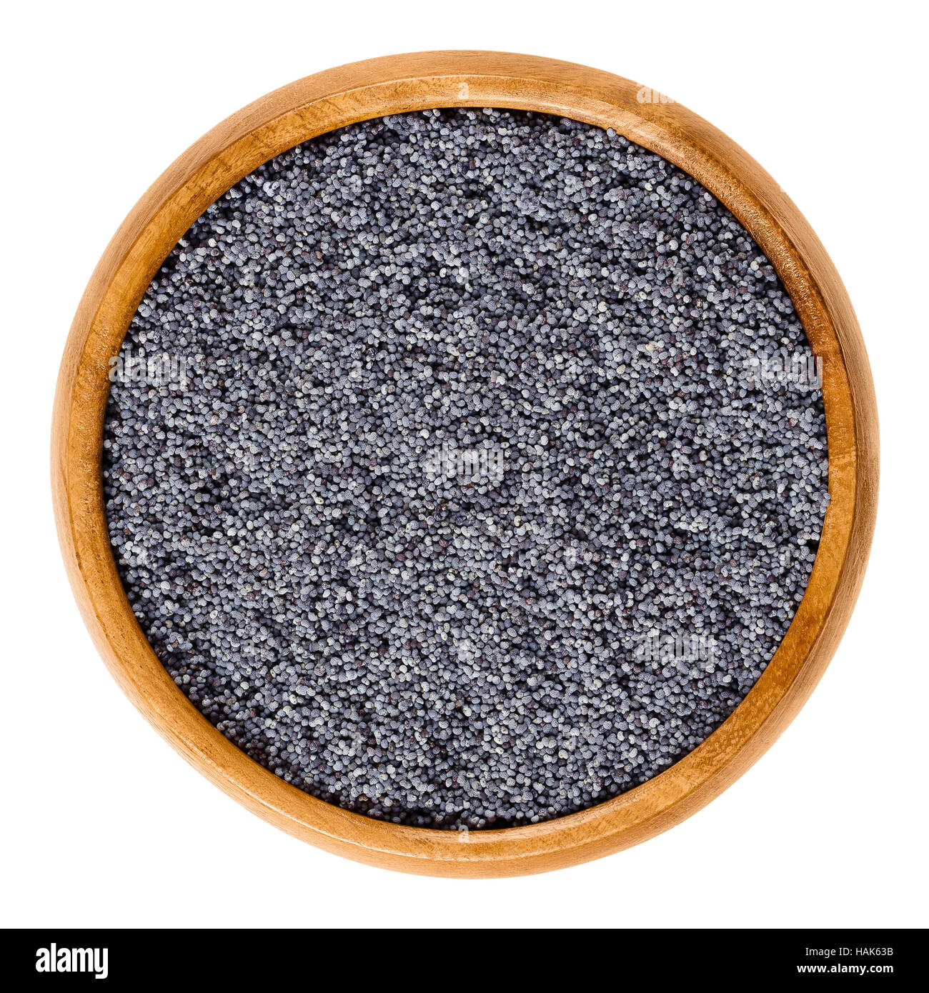 Blue poppy seeds in wooden bowl. Oilseed from opium poppy Paper somniferum with tiny kidney shaped seeds. Dried fruits. Stock Photo