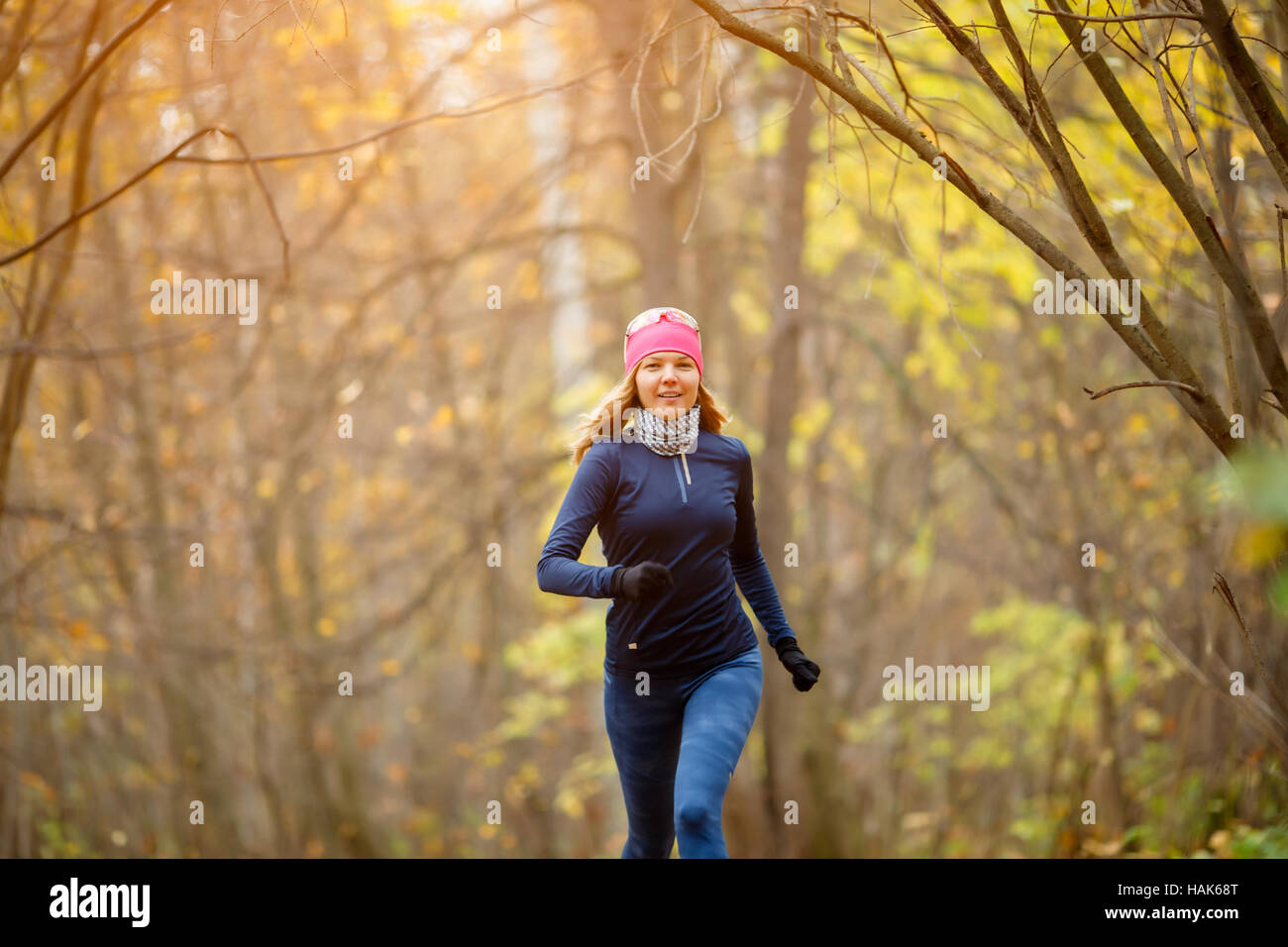 Young girl running in morning in autumn forest Stock Photo Alamy
