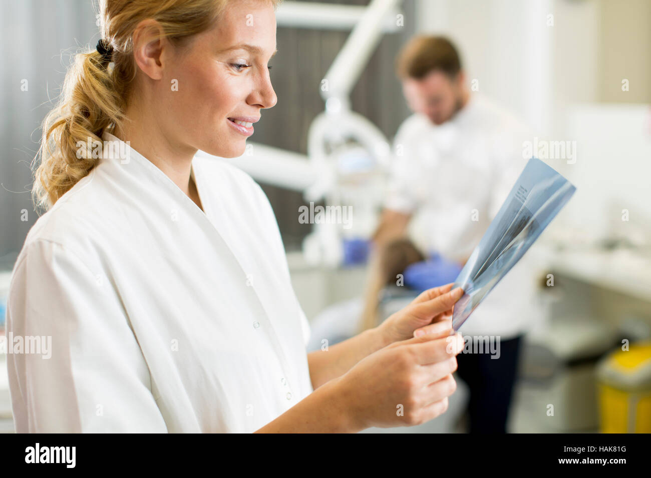 Female dental specialist examines an xray of the tooth while in