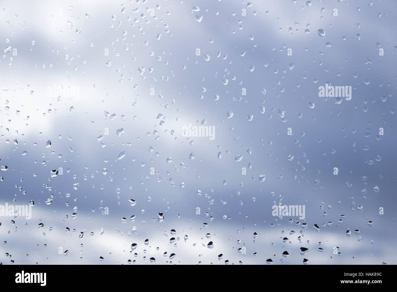 Rain drops on window on a cloudy day Stock Photo
