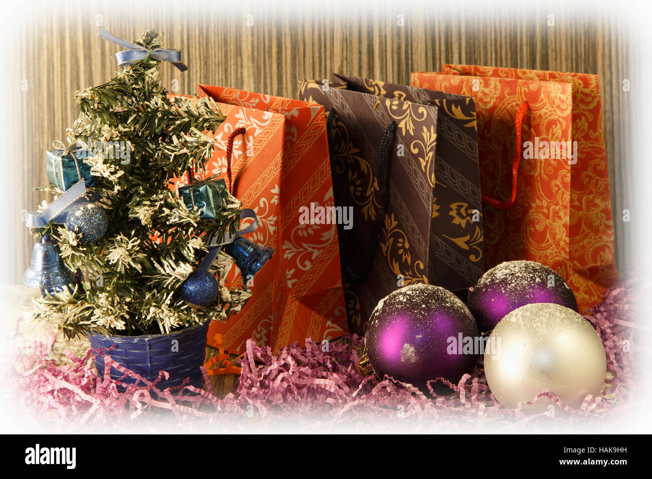 small manmade Christmas tree with toys and bows on wooden and fabric