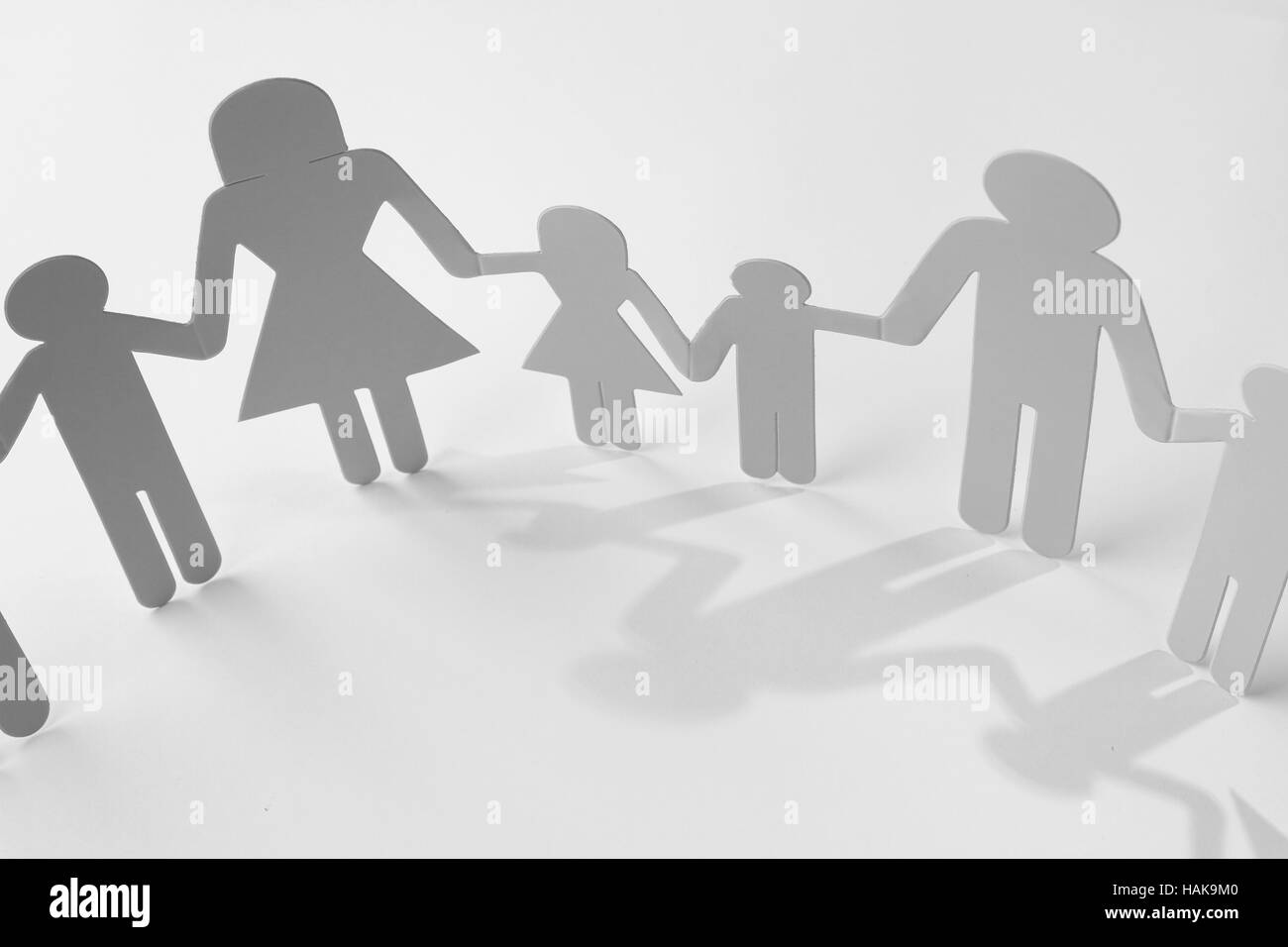 Family paper chain cutout holding hands Stock Photo