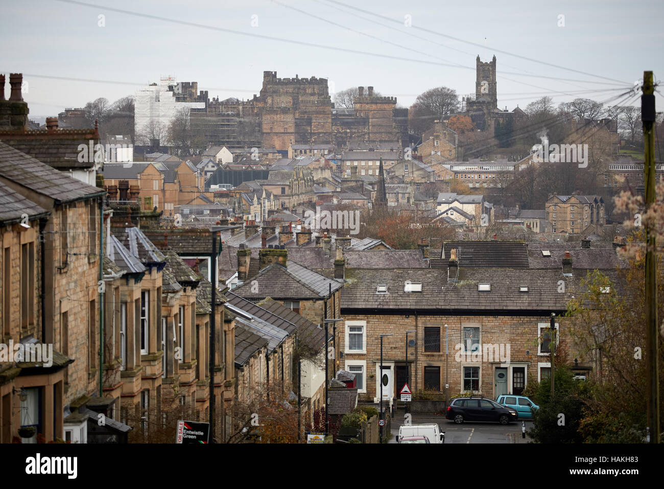 Lancashire Lancaster street scene skyline   Town centre backdrop looking down steep hill terraced houses stone traditional cityscape landscape parked Stock Photo