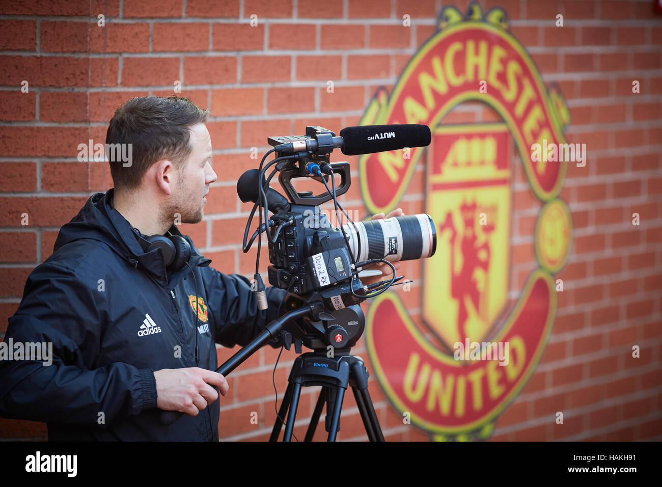 MUFC TV Manchester United filming   in house tv station MUTV filming in Stadium Sporting sports logo managers dugout home team recording interview cam Stock Photo