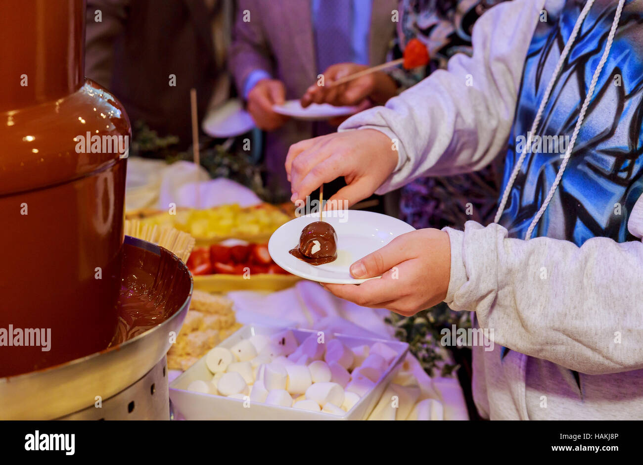 Closeup of squeezing filling of salted caramel cream from confectionery bag  into candy molds for preparing handmade chocolate pralines Stock Photo -  Alamy