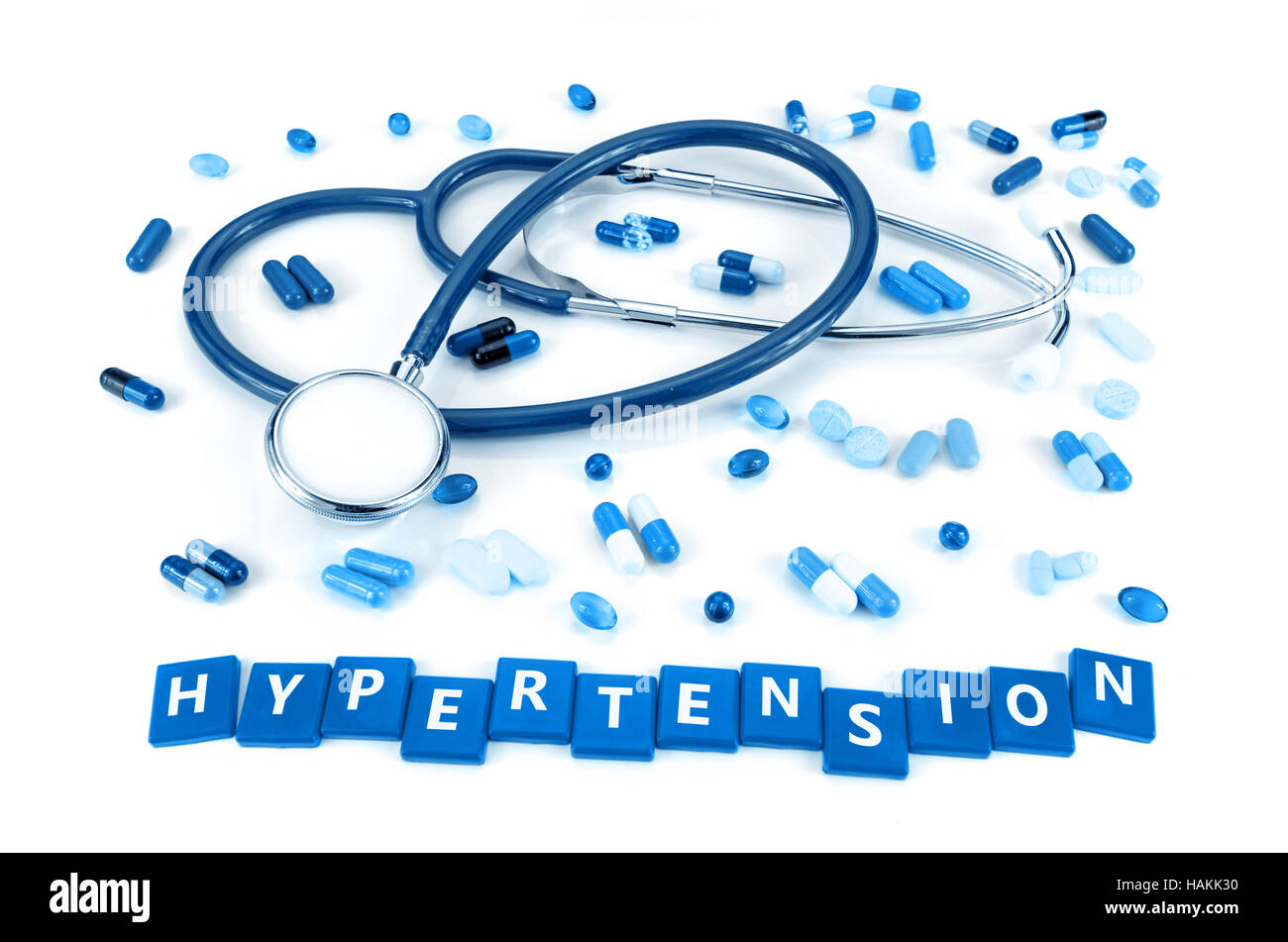 Hypertension treatment concept with stethoscope and various kind of oral merication on white background. Stock Photo