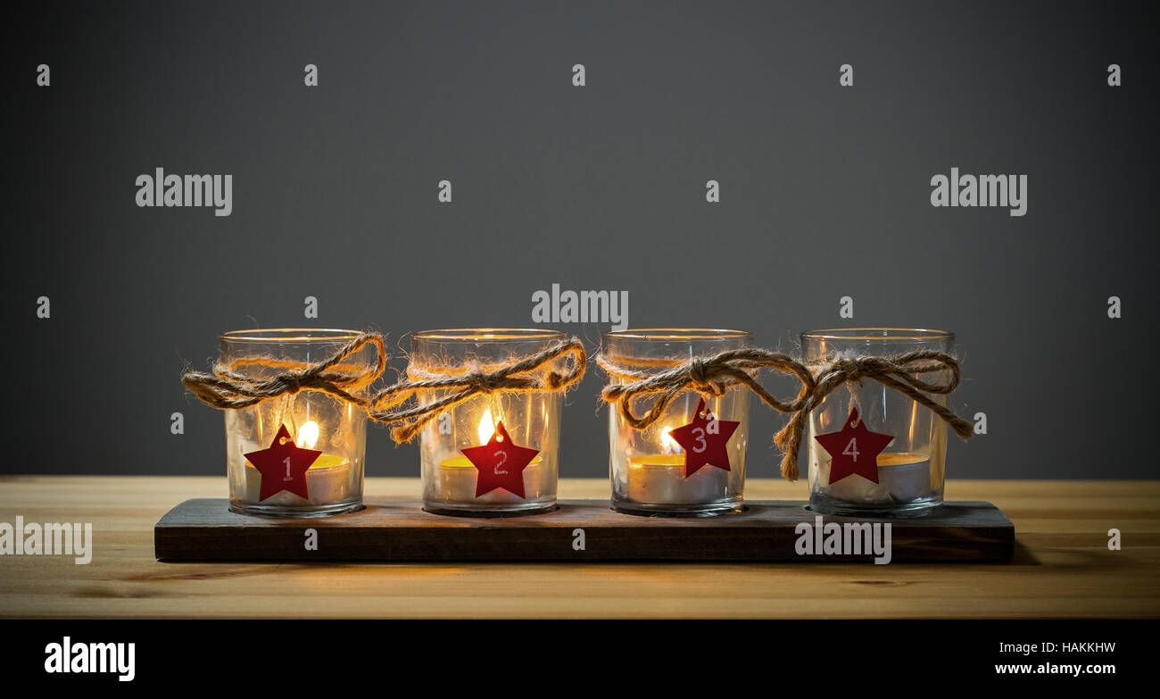 Four Advent candles on grey Stock Photo