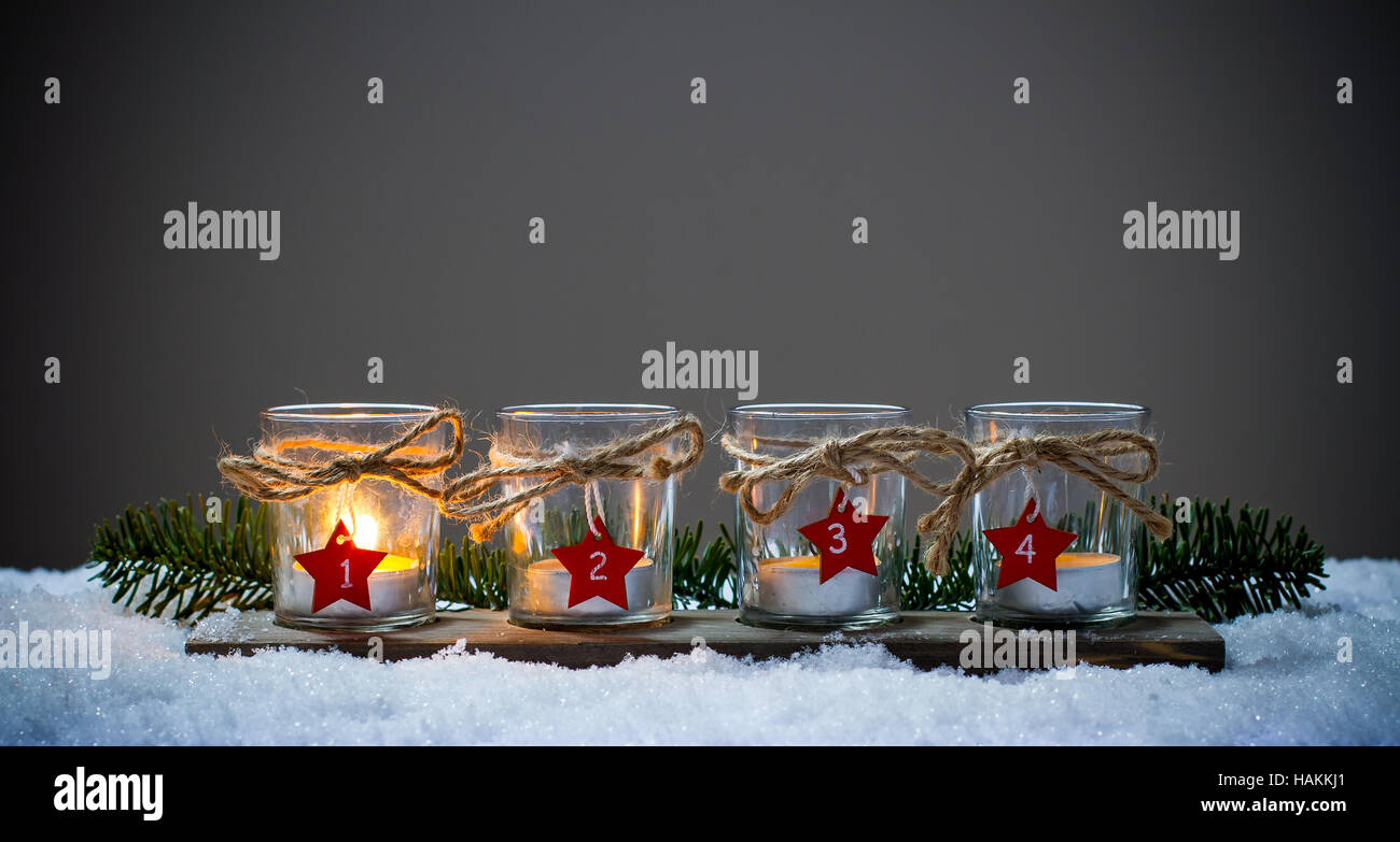 Four Advent candles in the snow, first Advent Stock Photo