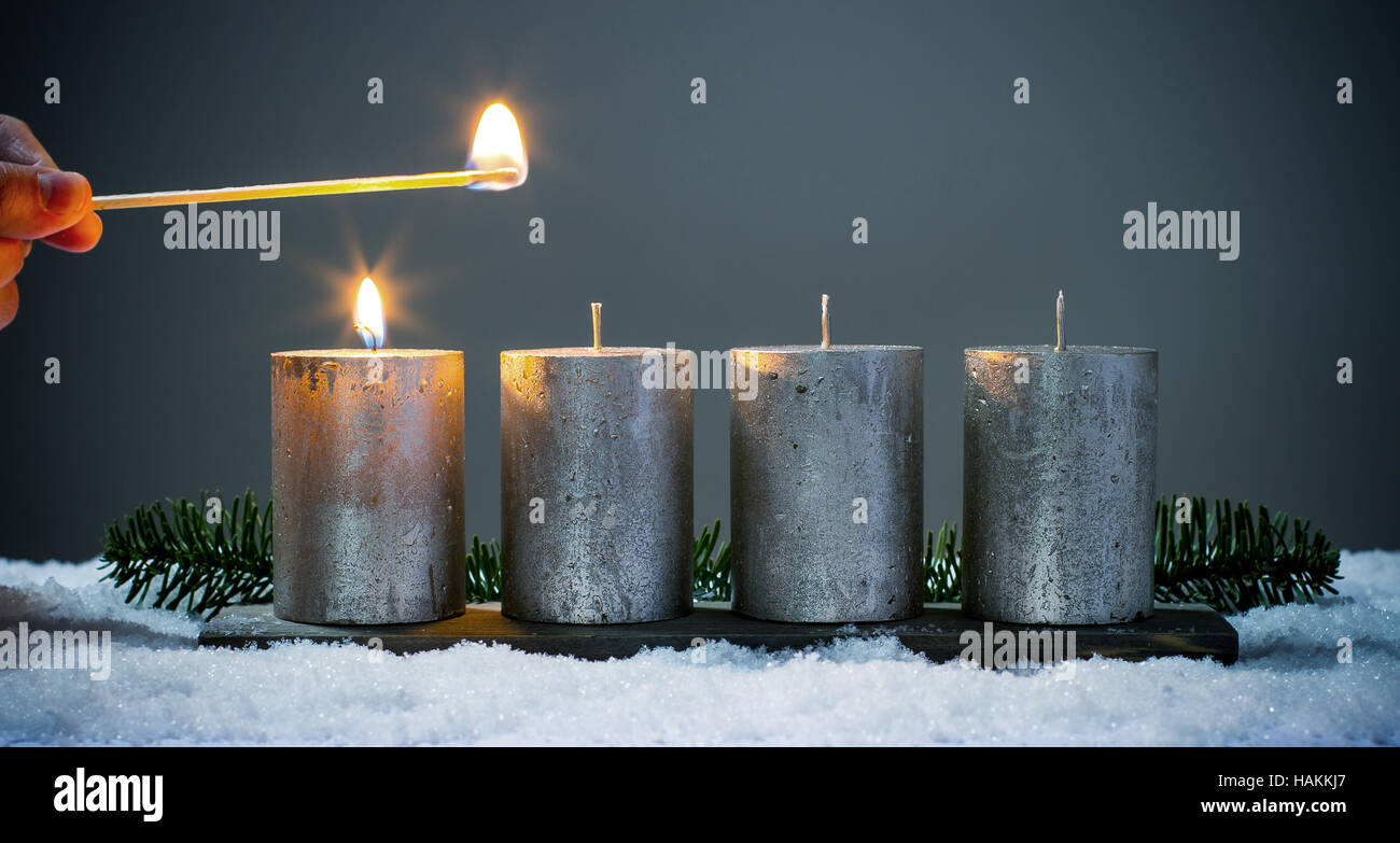 Light four advents candles with matches Stock Photo Alamy