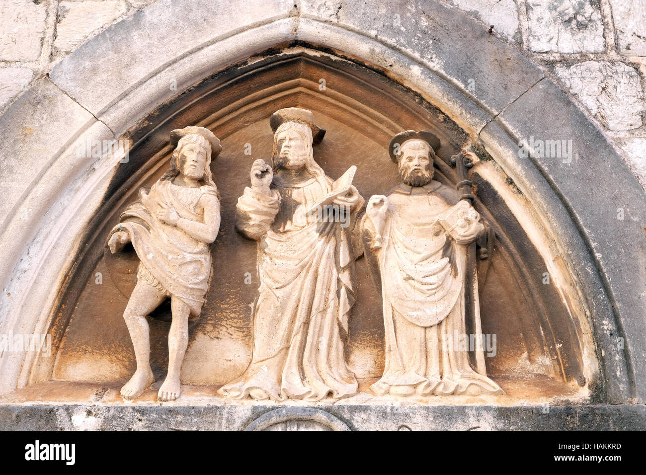 Jesus Christ, St. John the Baptist and St. Nicholas with a stick, portal of Saint Luke Church in Dubrovnik, Croatia Stock Photo