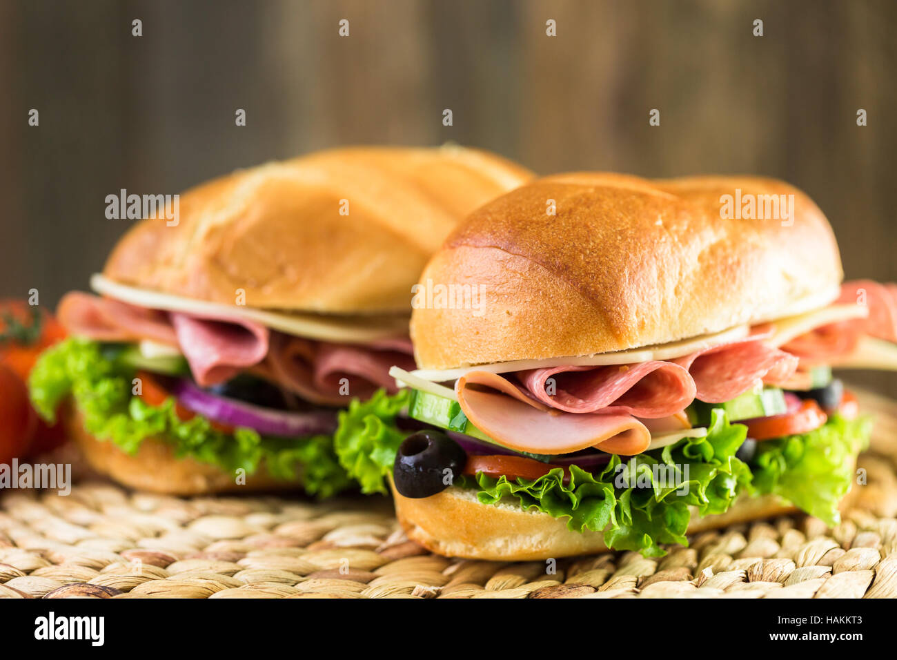 Sub sandwich with fresh vegetables, lunch meat and cheese on hoagie