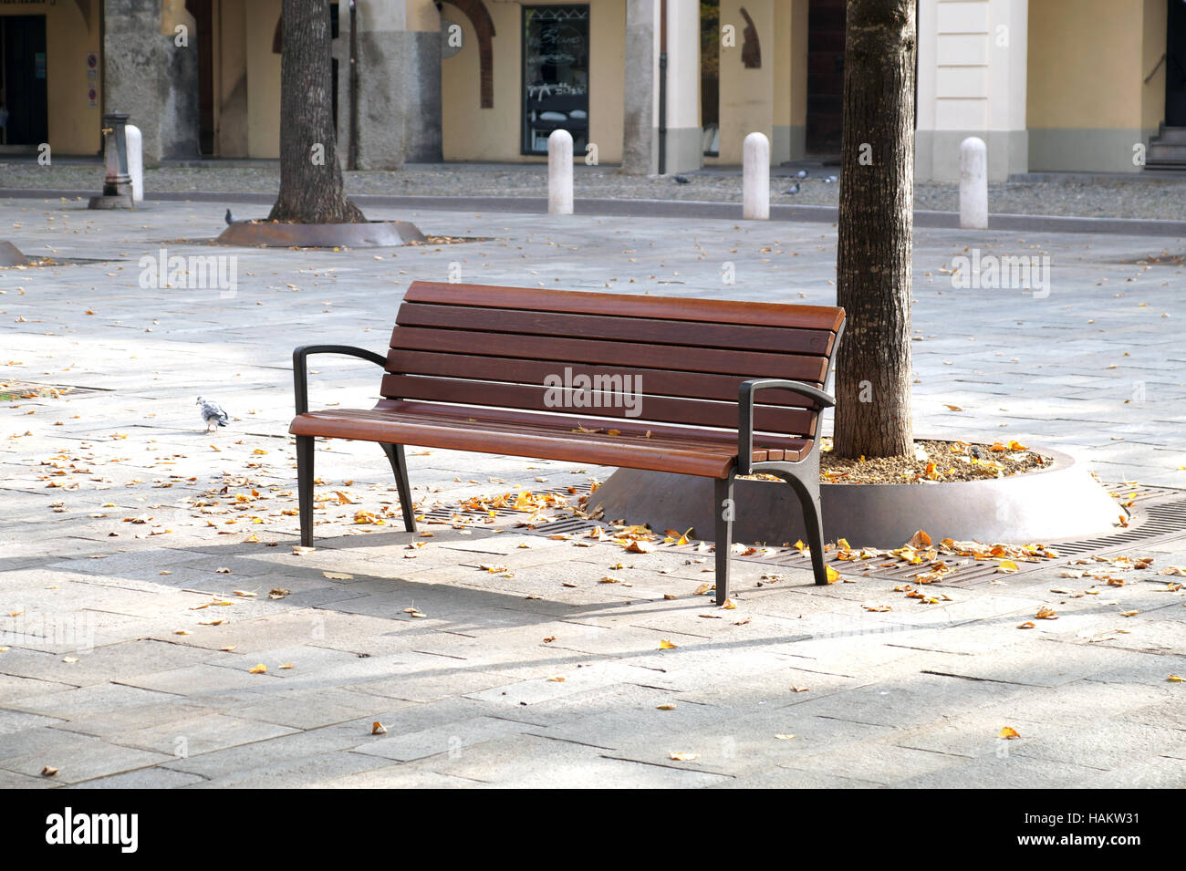 Vintage style wooden bench on the city square Stock Photo Alamy