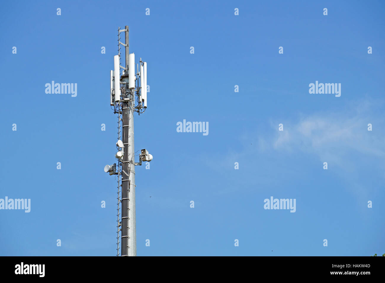 Transmitter antenna over blue sky for mobile connection Stock Photo