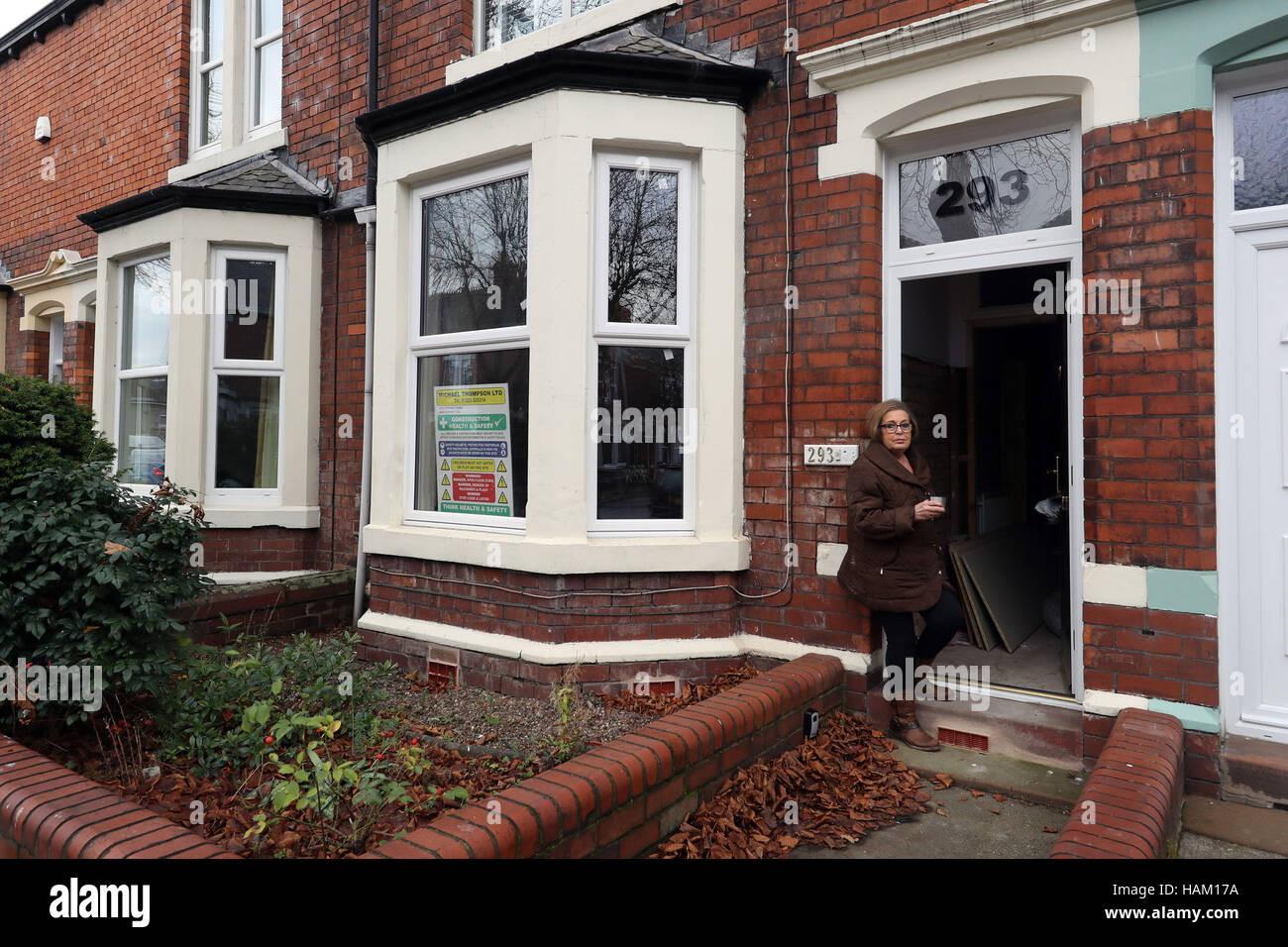Pensioner Anne Reay from Warwick Road in Carlisle sits outside her home - one of hundreds of people facing another miserable festive season a year on from Storm Desmond. Stock Photo