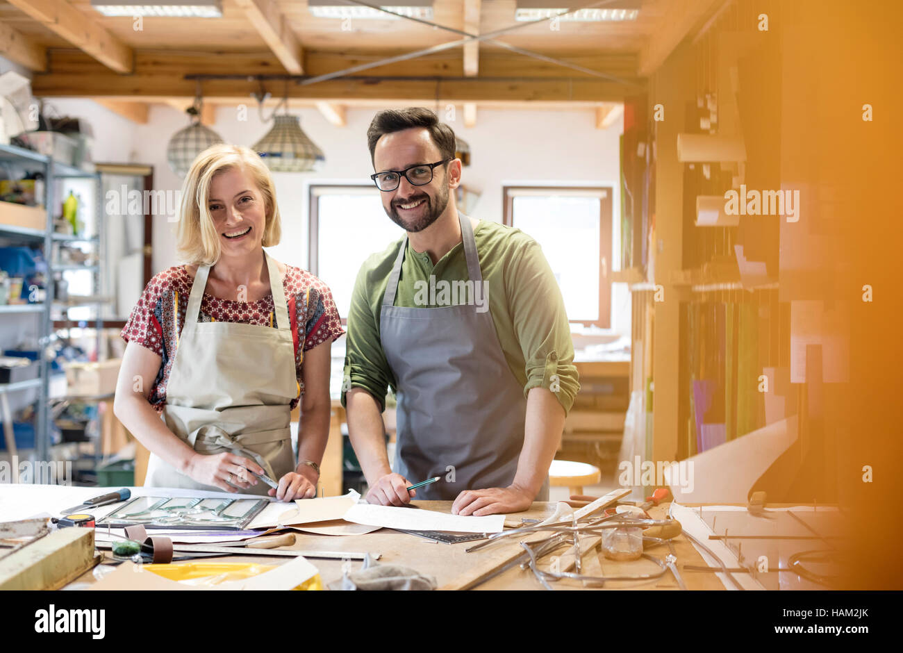 Portrait smiling stained glass artists working in studio Stock Photo Alamy