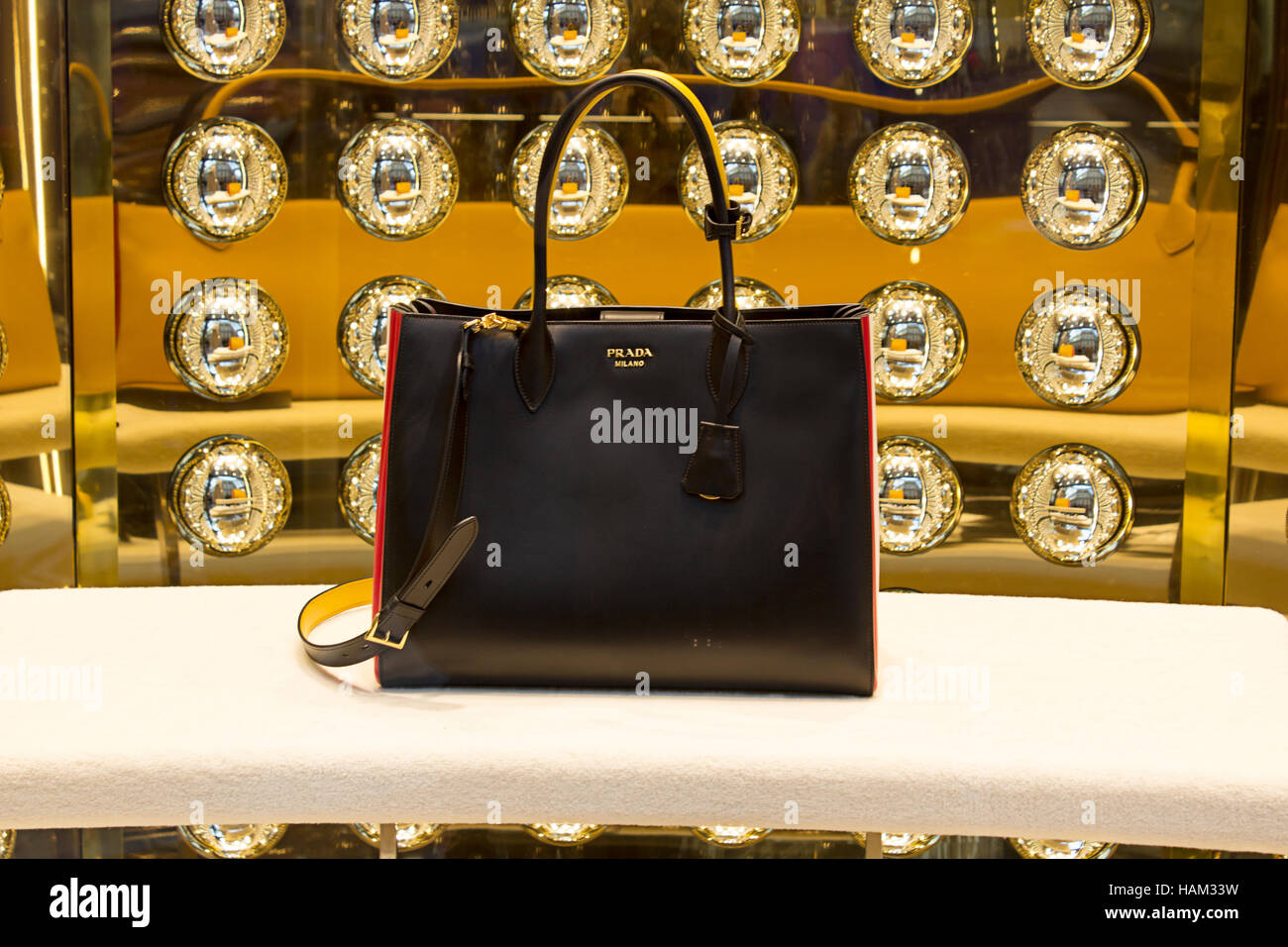 Haute couture accessory fashion window: Prada woman leather bags and  elegant decolte shoes, with gold details and chain Stock Photo - Alamy