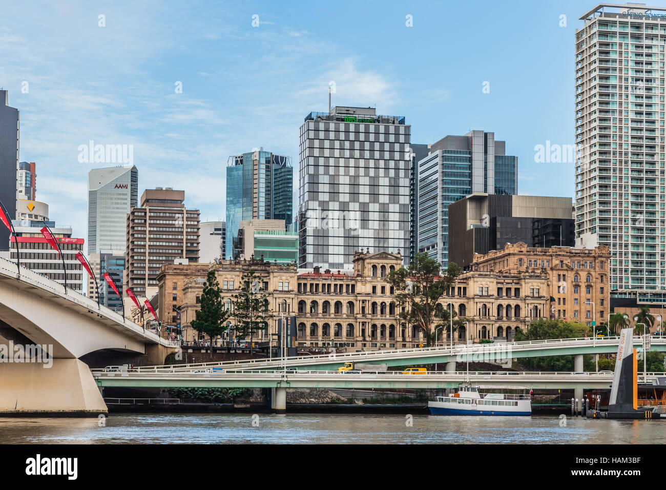 Treasury Building, Brisbane, seen from the river, surrounded by high-rise buildings. Stock Photo