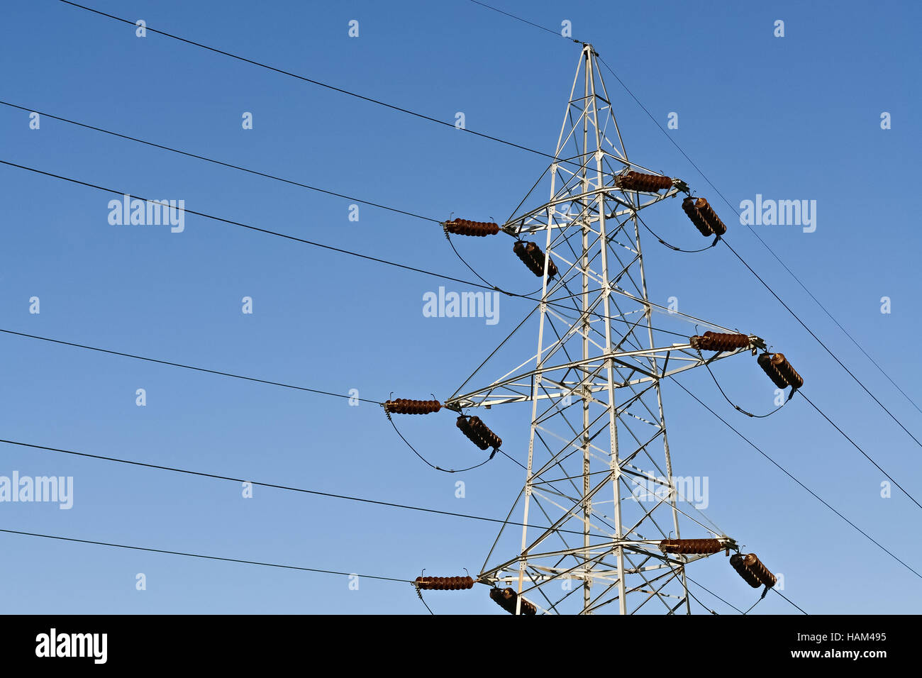 High voltage steel power line and clear blue sky Stock Photo - Alamy