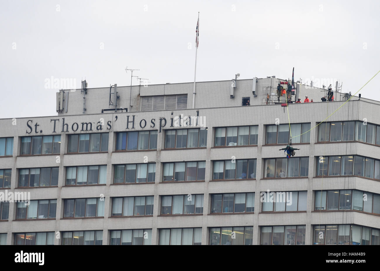 A fundraiser zip wires across the Thames from the roof of St Thomas' Hospital to the Houses of Parliament to launch a period of Christmas fundraising in aid of the Evelina London Children's Hospital. Stock Photo