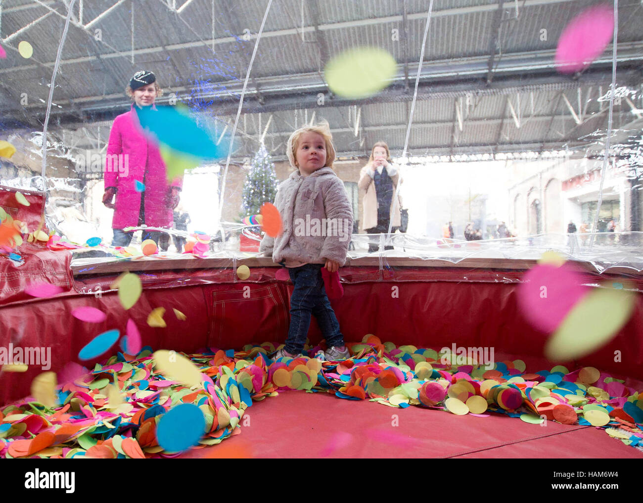 EDITORIAL USE ONLY Siobhan Fitzgerald and her daughter Aoife Cunnington play at an attraction unveiled by online shopping hub Notonthehighstreet.com in celebration of 'Colour Saturday', at King's Cross in London. Stock Photo